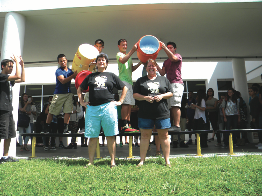 Social Studies teacher Renee Manwaring (left) and English teacher Kelly Lawrence prepare to get doused with ice water as they take part in the ALS Ice Bucket Challenge in front of hundreds of students during first lunch on the second day of school.