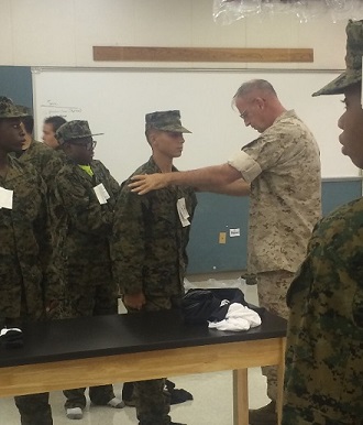 JROTC cadet Marcus Rivera undergoes uniform inspection by Col. Ingersoll.