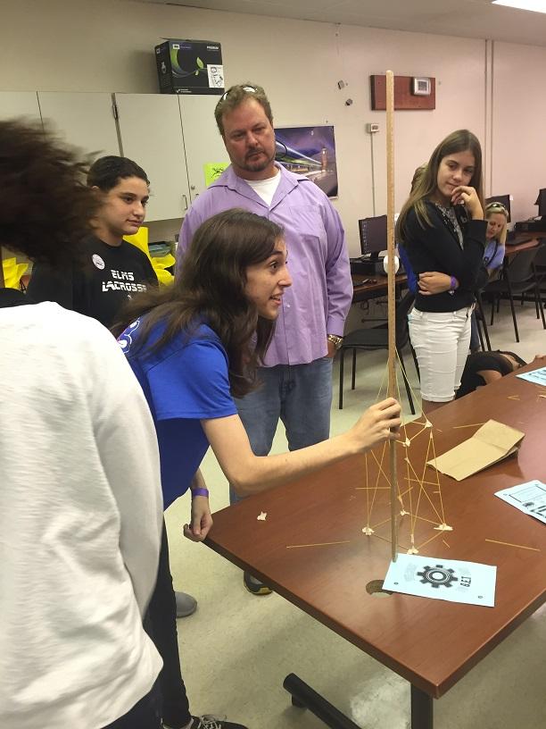 Julia+Berger%2C+a+senior+in+the+OH+Engineering+Academy+measures+a+tower+built+using+only+spaghetti+noodles%2C+one+marshmallow%2C+and+one+strip+of+tape.+The+tower+building++exercise+was+just+one+of+the+G.E.T.+day+activities.
