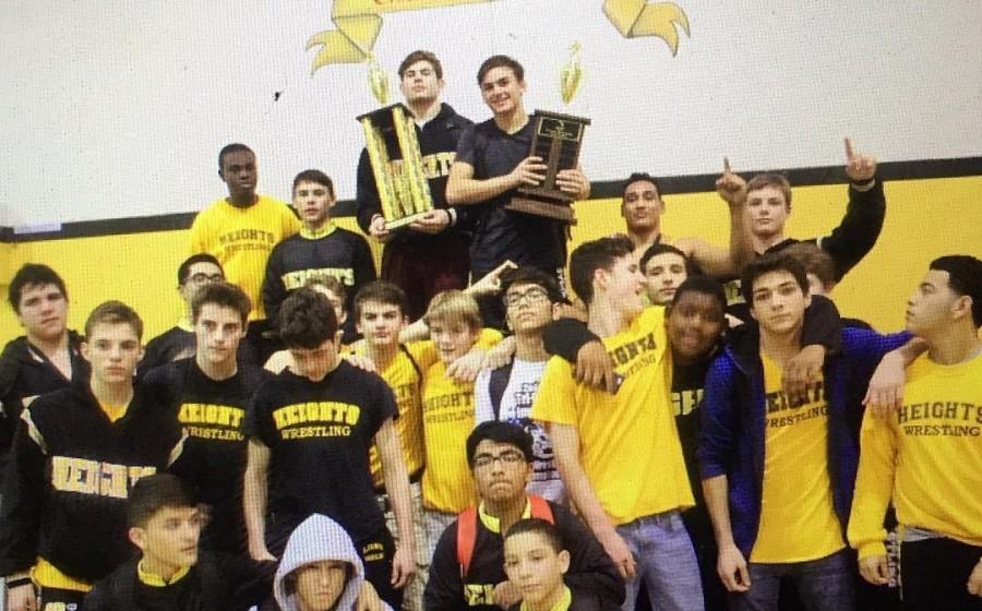 The Olympic Heights wrestling team celebrates its championship at the Tri-County Meet.