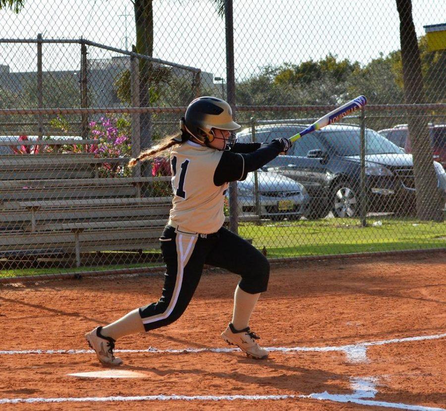 Theresa Stettner collects one of her three base hits in the Lions softball team 9-2 win over Cardinal Newman, on Monday, Feb. 13.