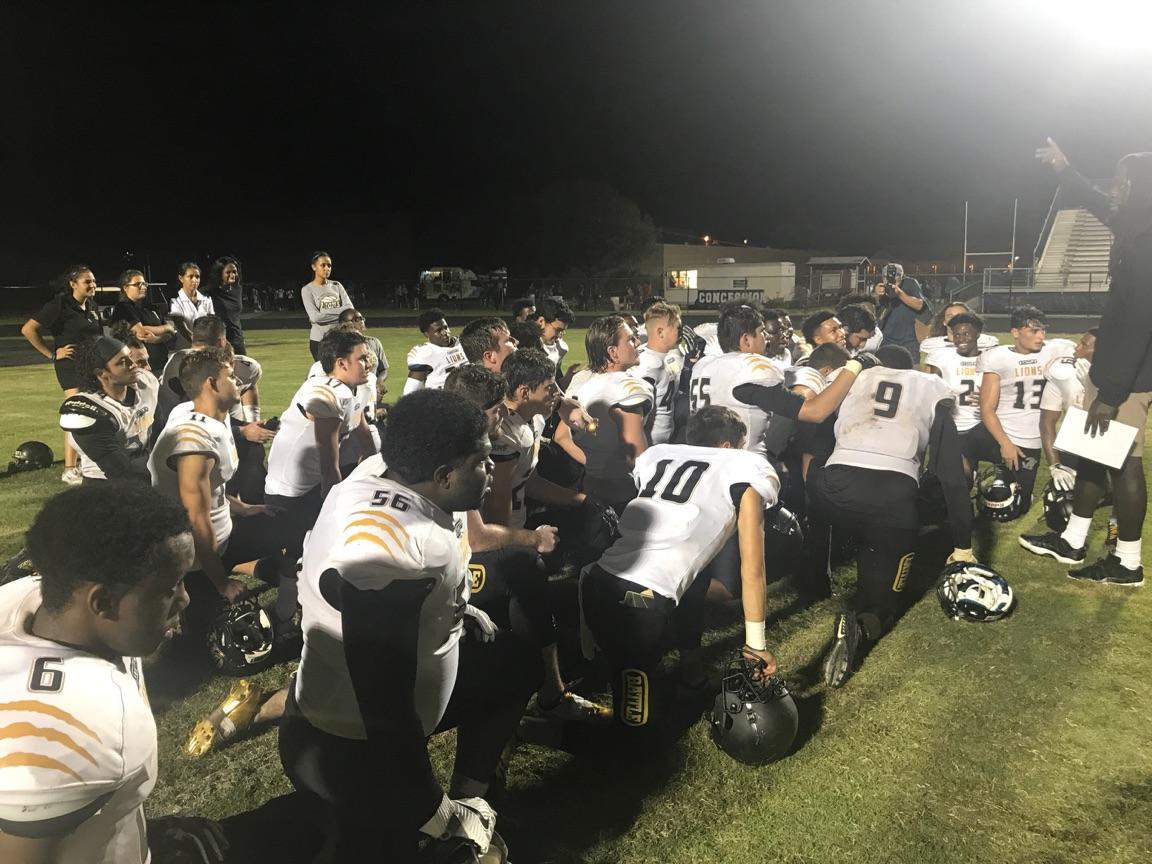 The OH  football team listens to words of praise from defensive coordinator  Bieness Coach B Alfred after its upset of Dwyer.
