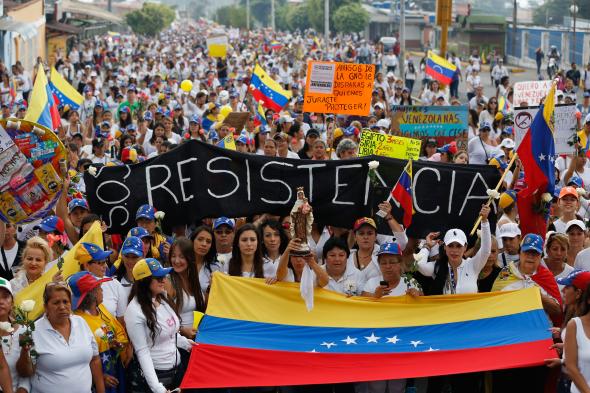 Opposition demonstrators participate in a womens rally against Venezuelan President Nicolas Maduros government in San Cristobal on February 26, 2017.