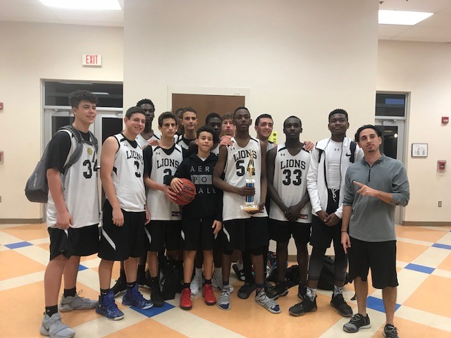 The Olympic Heights Boys  JV Basketball Team pose with their second place trophy  from the Park Vista Holiday Tournament.