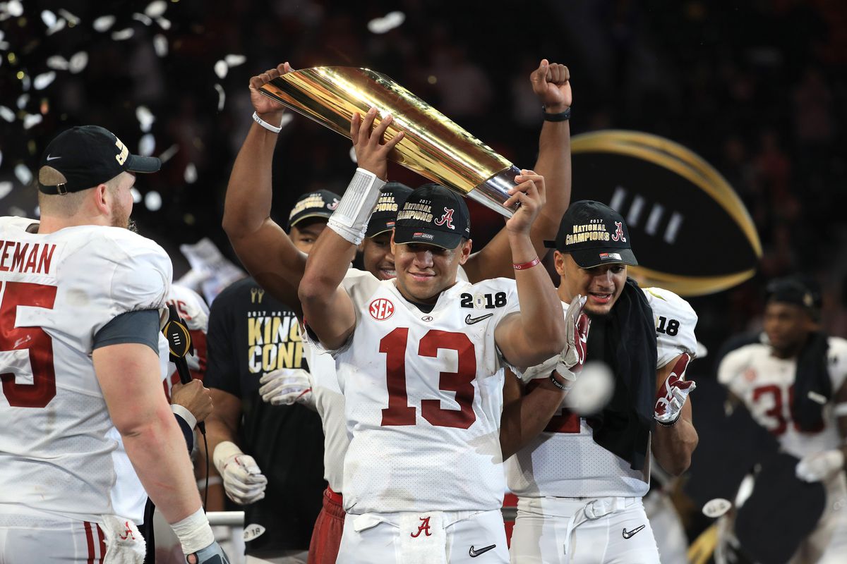 Alabama QB Tua Tagovailoa hoists the championship trophy after leading the Crimson Tide to a comeback victory.
