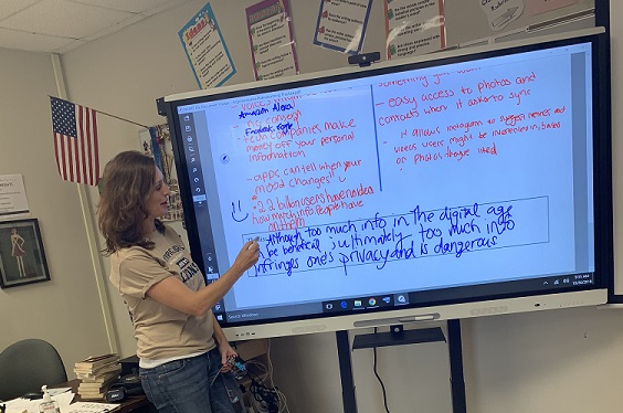 Ms. Vanessa Koher takes her AICE English General Paper class through a lesson utilizing her SMART Board.