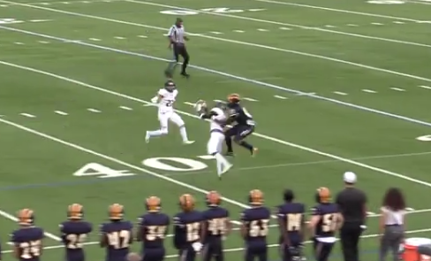 Olympic Heights cornerback Patrick Pierre (in white) intercepts a Boca Raton pass on the opening drive of the game.