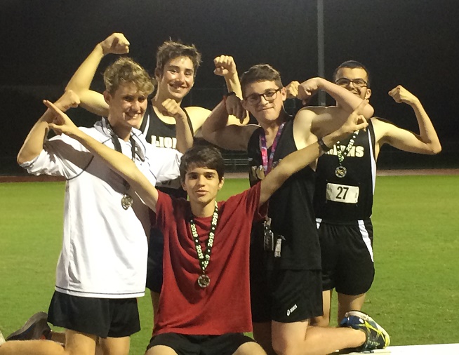 Members of the Olympic Heights boys cross country team celebrate a strong showing.