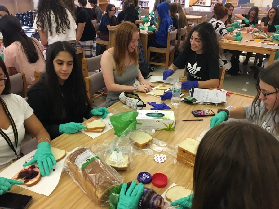 At a recent meeting, OH Key Club members make peanut butter and jelly sandwiches for the homeless.