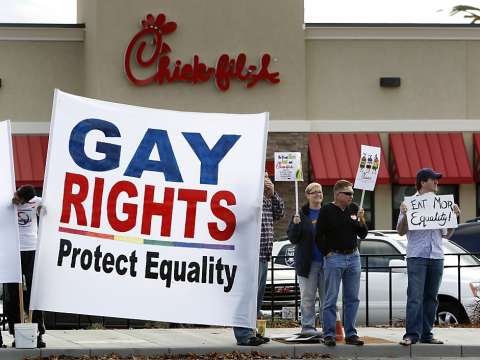 A pro-LGBTQ rights group protests Chick-fil-A donations to anti-LGBTQ organizations.