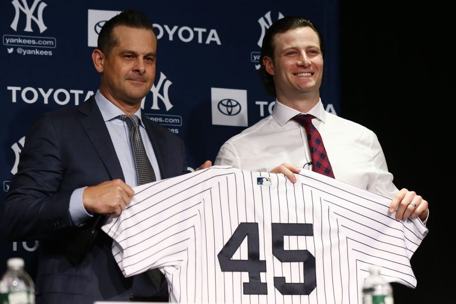 Gerrit Cole (right), pictured with Yankees manager Aaron Boone at his contract signing, became the highest paid pitcher in MLB history with his nine-year, $334 million contract.