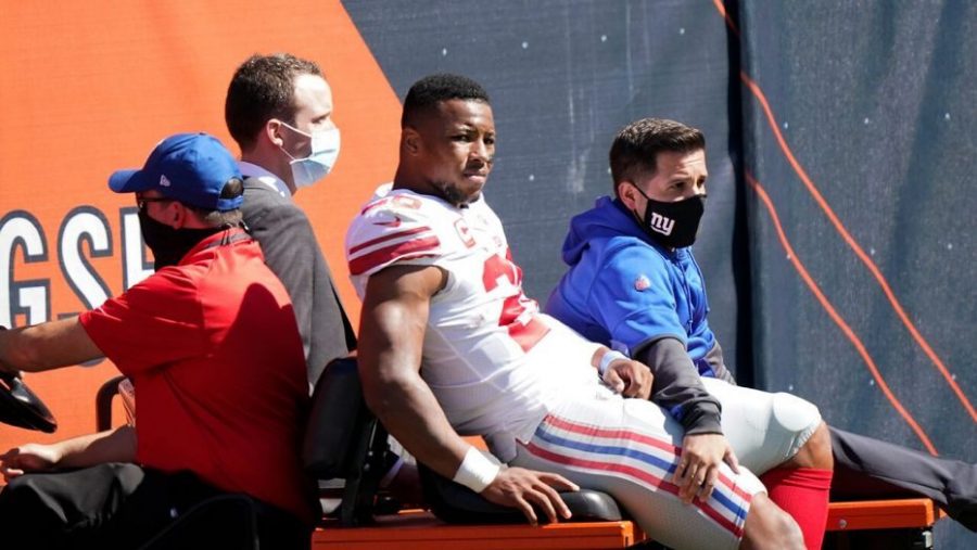 New York Giants star running back Saquon Barkley is carted off the field after suffering a season-ending torn ACL in last Sundays loss to the Chicago Bears. 