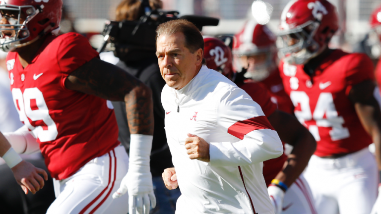 The Alabama Crimson Tide, led by head coach Nick Saban (center), have been an unstoppable force this NCAA season and are favored to win their fifth national championship in the past ten years.