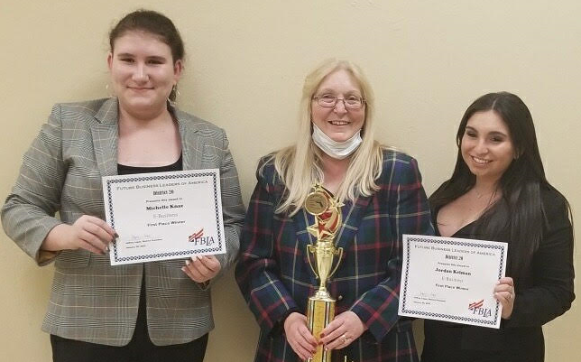 FBLA+members+Michelle+Knaz+%28left%29++and+Jordyn+Kelman+%28right%29+celebrate+with+advisor+Ms.+Cheryl+Shimmel+after+placing+first+in+the+E-business+category+at+district+competition.+