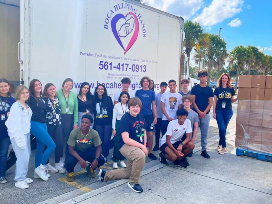 Members of the Olympic Heights National Honor Society, under the direction Ms. Vanessa Koher (far right), collected over 200 Thanksgiving meal boxes for Boca Helping Hands.