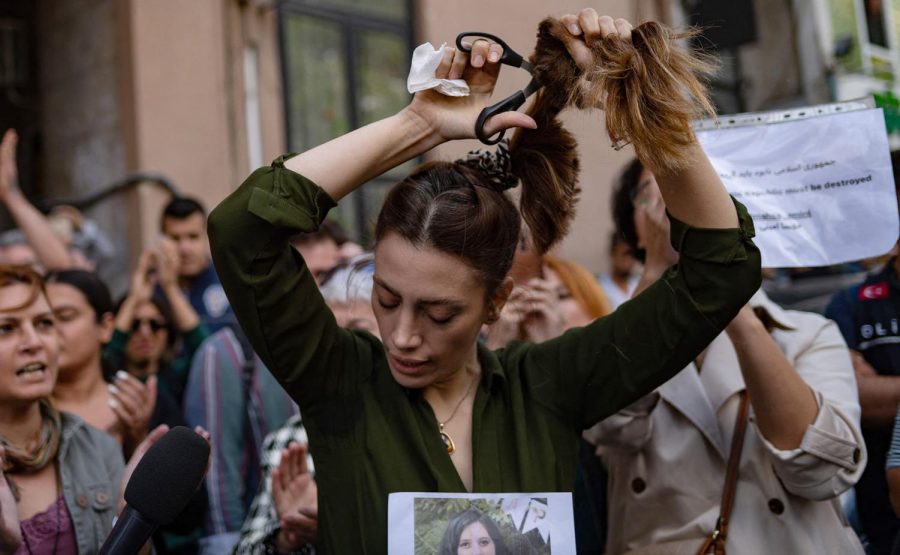 An+Iranian+woman+cuts+off+her+hair+in+protest+of+Mahsa+Aminis+death+while+in+custody+of+Iranian+law+enforcement+after+being+arrested+for+wearing+a+loose-fitting+hijab.