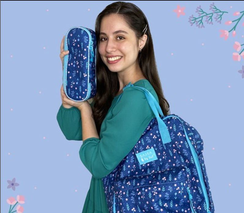 Olympic Heights senior Sophia Martins displays a pencil case and a bookbag from her personal Lilac Fields Collection line of student accessories that can be purchased online.