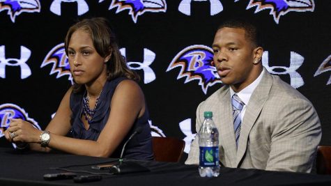 Former Baltimore Ravens running back Ray Rice addresses the media in 2014 regarding his domestic abuse charges. He is seated with his wife Janay, the victim of the abuse who was his fiancée at the time of the incident.