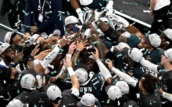 Philadelphia Eagles players celebrate with the Vince Lombardi Trophy at the end of Super Bowl 59